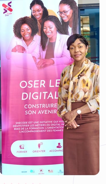 Membre de SheCode devant la bannière « Oser le digital, construire son avenir »